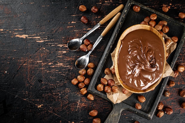 Hazelnut butter in a plate on a cutting board with paper