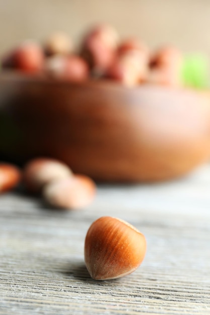 Hazelnut on wooden bowl background