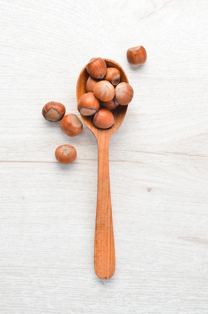 Hazelnut in a wooden spoonTop view Free space for your text