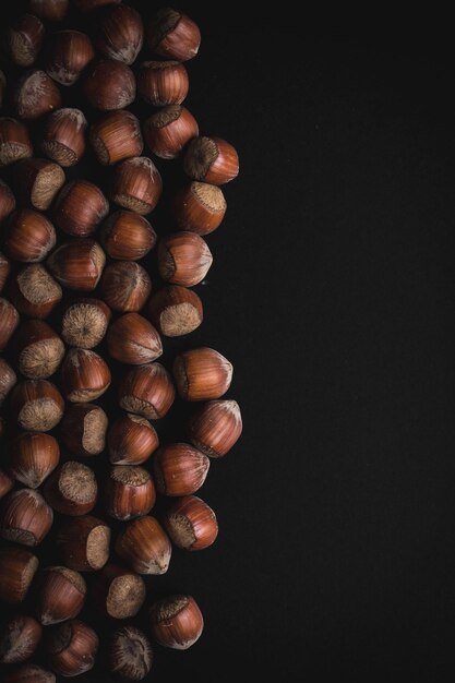 Hazelnuts on black background Food background vertical photo wallpaper