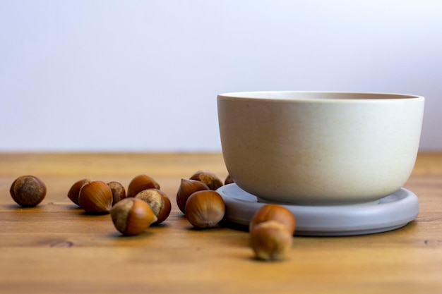 Hazelnuts in the bowl on wooden table