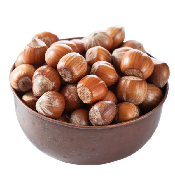 Hazelnuts in copper bowl isolated