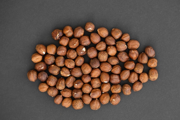 Hazelnuts on dark rustic wooden background