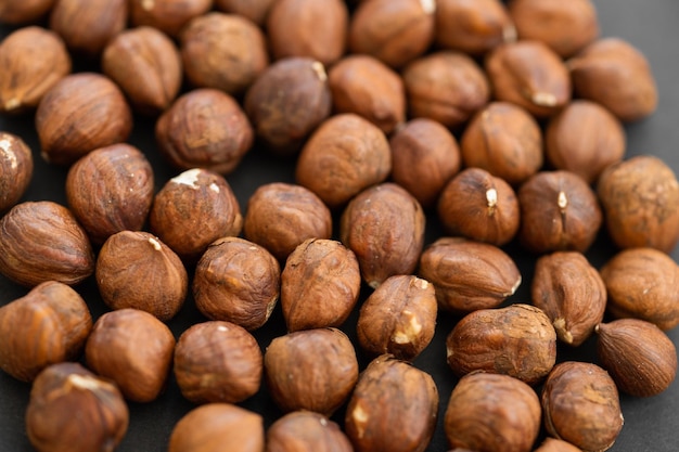 Hazelnuts on dark rustic wooden background