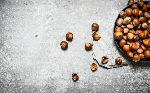 The hazelnuts in an old pan on the stone table