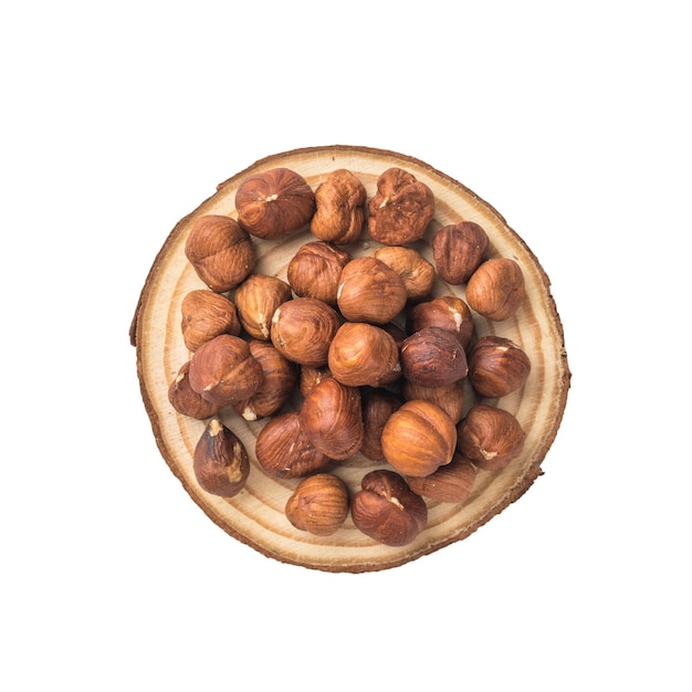 Hazelnuts on a piece of wood isolated on a white background