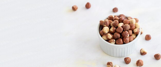 Hazelnuts in plate on white background