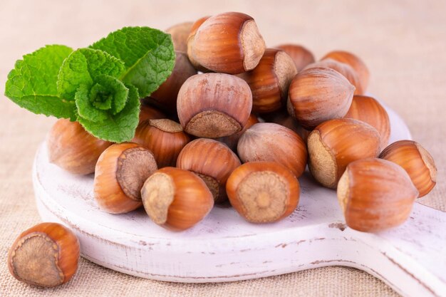 Hazelnuts on a white wooden board Closeup