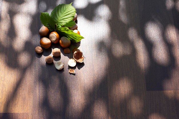 Hazelnuts with leaves on wooden background