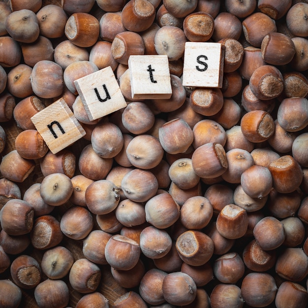 Photo hazelnuts with wooden letters.