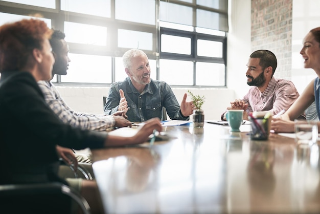 He always has the best ideas. Shot of a team of businesspeople having a meeting in an office.