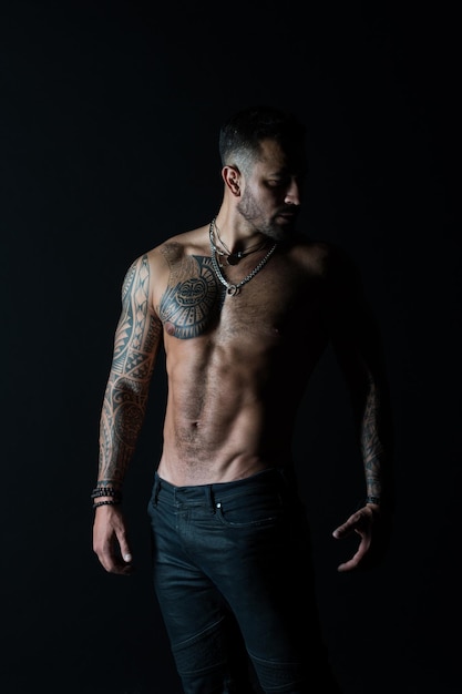 He got perfect torso Tattoo man with sexy bare torso in jeans Bearded macho with tattooed body Athlete with sexy bare torso in jeans Sportsman with muscular chest and belly Sport and fitness