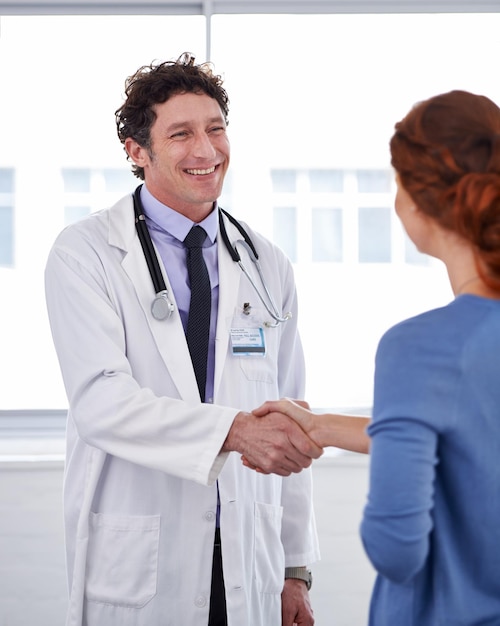 He has a good bedside manner Cropped shot of a doctor and shaking his patients hand