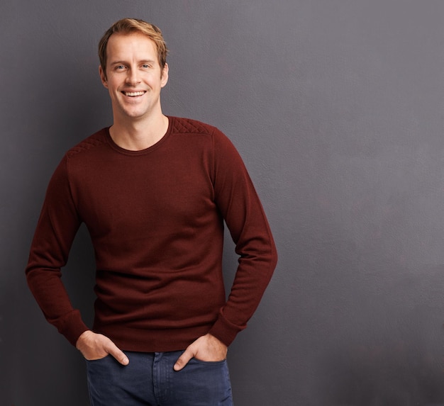 He has a relaxed outlook Portrait of a handsome young man in a studio in front of a gray background