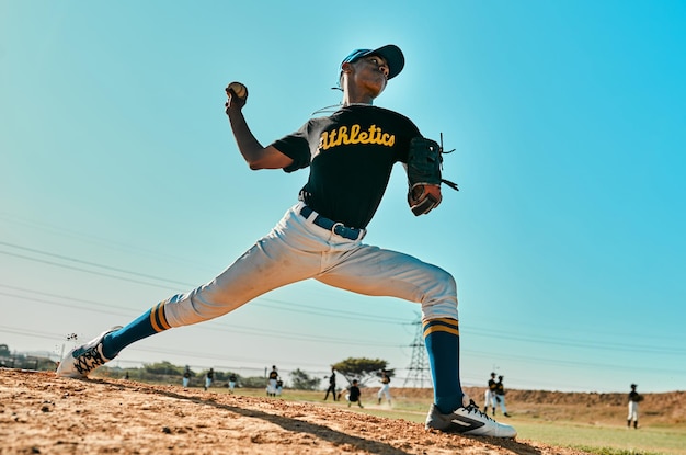 He has a strong throwing arm shot of a young baseball player pitching the ball during a game outdoors