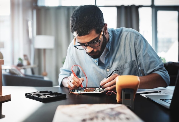 he has the technical knowledge to make this project a success cropped shot of a young engineer working from home