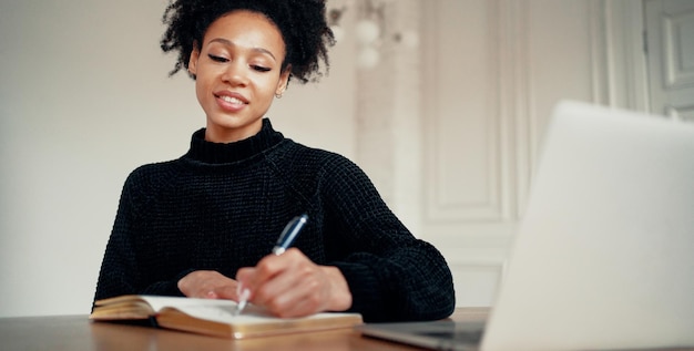 Photo he holds a fountain pen in his hands and shows a sincere smile the student is