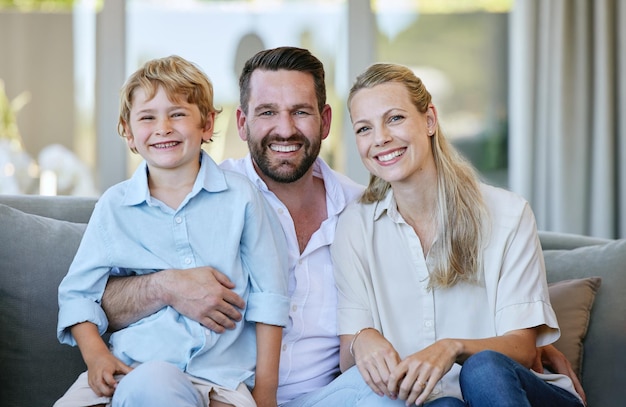 He is their pride and joy. Cropped portrait of an affectionate mature couple and their son sitting on the sofa at home.