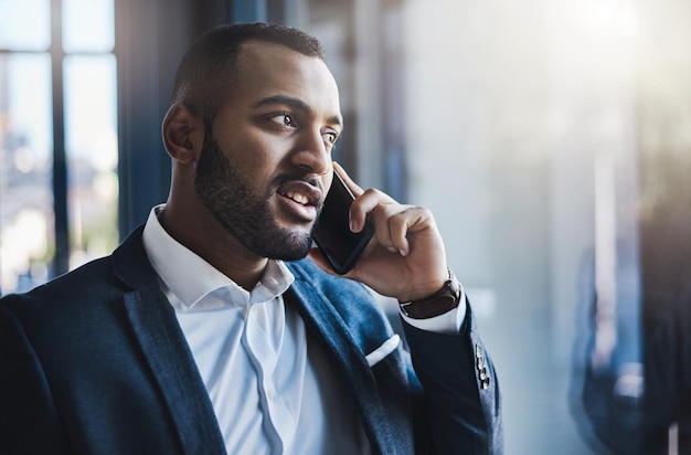 He knows what to say to close the deal Shot of a young businessman talking on a cellphone in an office