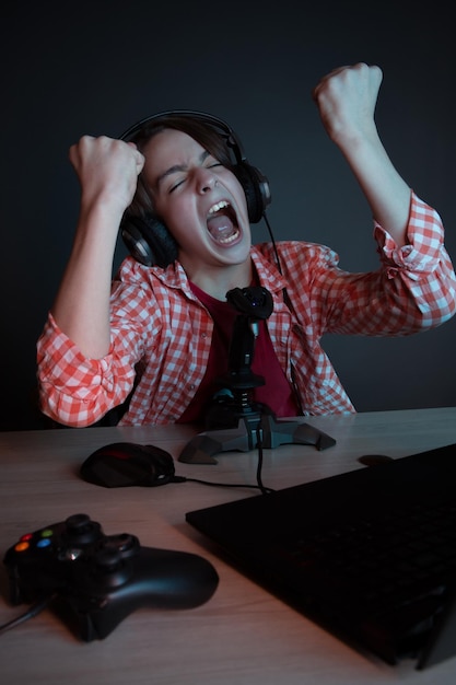 He like play and win video games in blue light of display\
emotional kid play computer games online