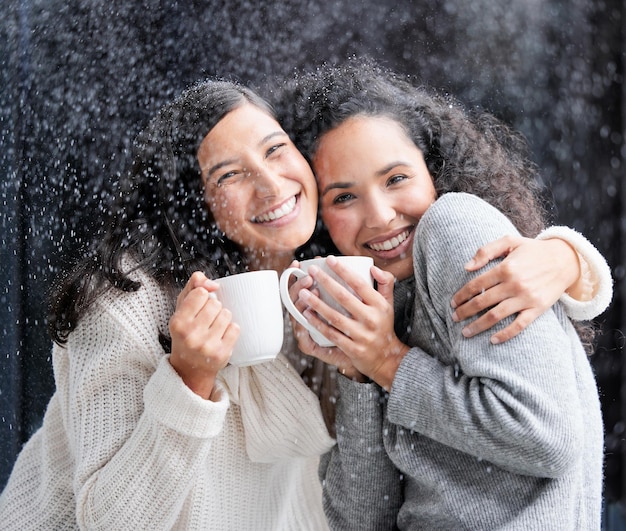 He who has not Christmas in his heart will never find it under a tree Shot of two young women drinking coffee in the snow outside