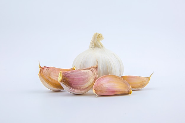 Head and cloves garlic isolated on a white .