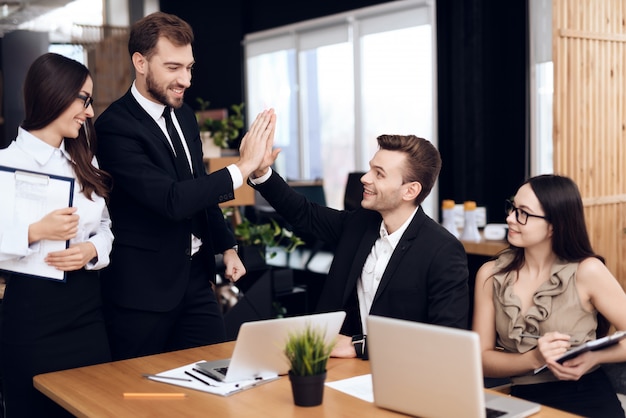 The head of the company talks with other employees