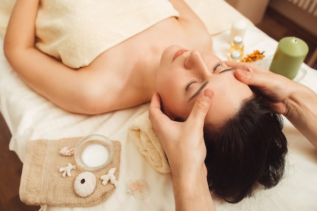 Head massage at beauty salon closeup