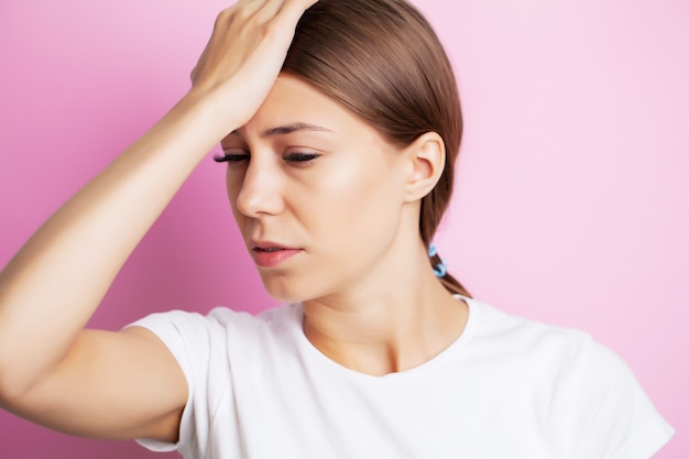 Head pain, exhausted young woman has suffering from unbearable headache