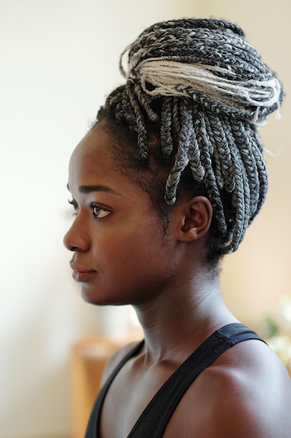 Premium Photo | Head of pensive young black woman with braided hair in bun  looking in front of her