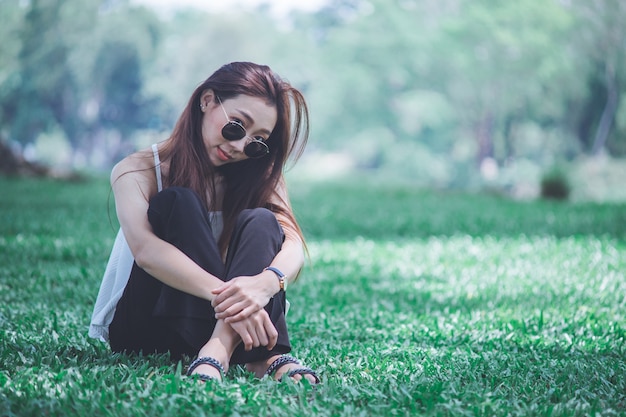 Head shot woman sitting in the lawn