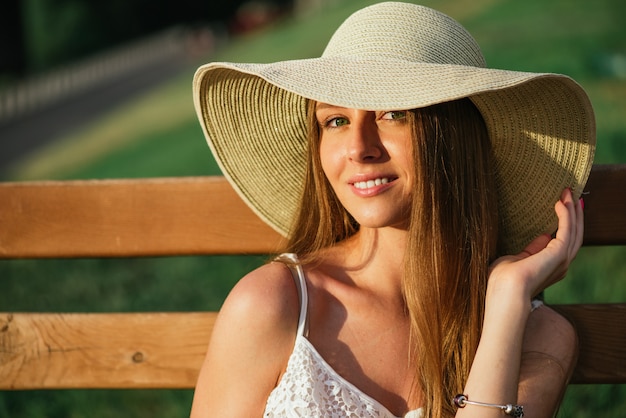 Head shot of young woman posing in park