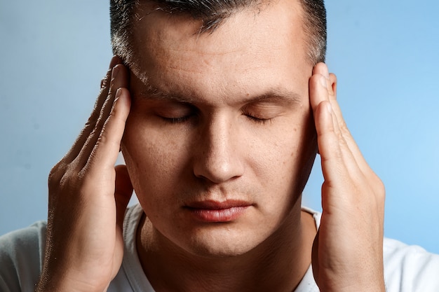 Headache. Portrait of a man close-up. Concept of the thought process