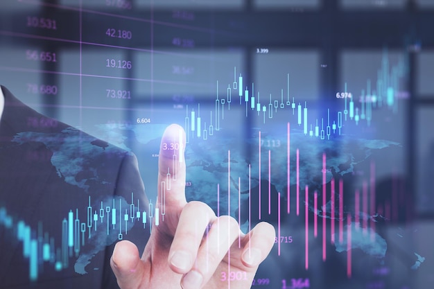 Headless busiessman pointing at glowing candlestick forex chart on blurry office iterior background Investment profit and financial growth concept Double exposure