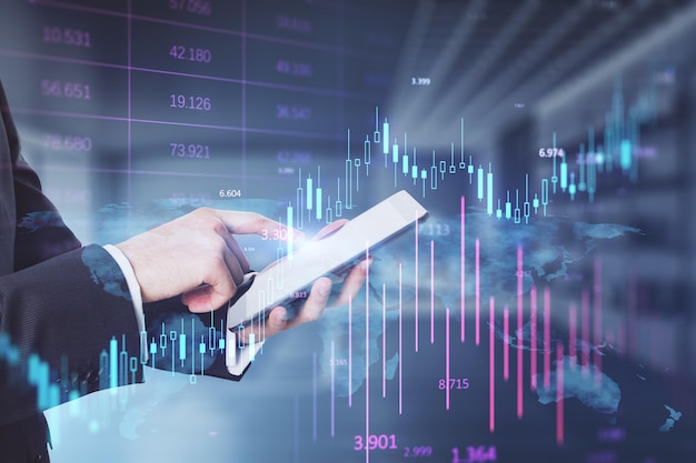 Headless busiessman using cellphone with glowing candlestick forex chart on blurry office iterior background investment profit and financial growth concept double exposure