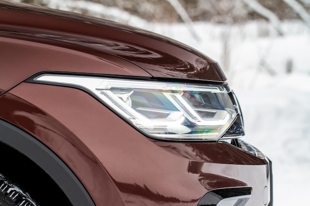 Headlight lamp of new cars Close up detail on one of the LED headlights modern car Exterior closeup detail Closeup headlights of car