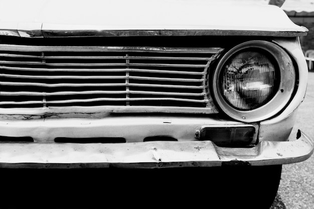 headlight lamp vintage classic car parked,  black and white vintage film grain filter effect styles