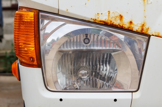 Photo headlight of a old truck closeup. front view