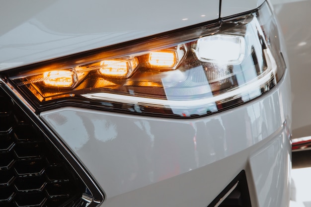 Headlight of a white modern car