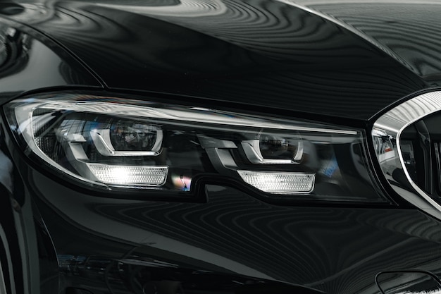 Headlights of a new white luxury car close up
