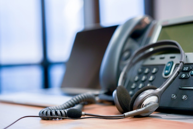 Photo headphone call centre hotline at computer office concept