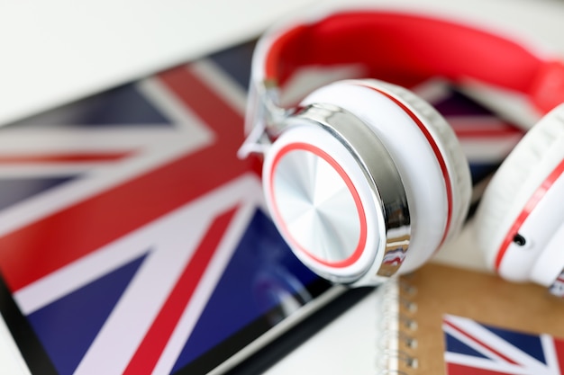 Headphones on the background of the flag of great britain