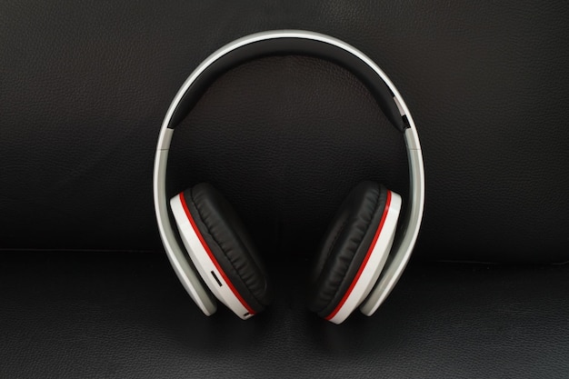 Headphones on black leather background