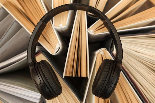 Headphones on books audiobooks concept books online education\
listening audio modern learning