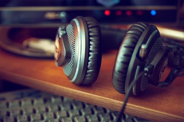 Headphones on a computer desk with dark toning