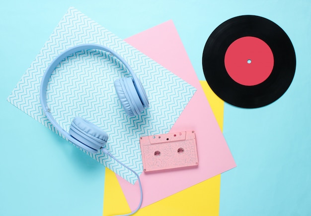 Photo headphones and earphones with audio cassettes on colored paper backgrounds