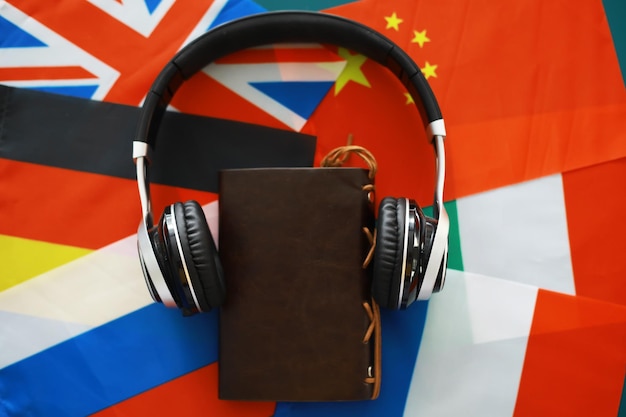 Headphones and flag. The study of foreign subjects. Audiobooks in a foreign language. Language classes. Listening.