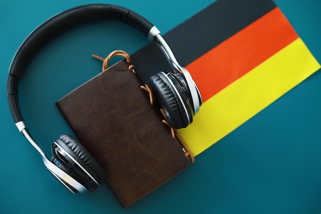 Headphones and flag The study of foreign subjects Audiobooks in a foreign language Language classes Listening