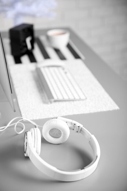 Photo headphones on gray table against defocused background