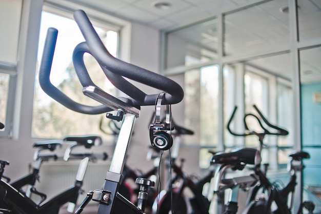 Headphones hanging on a stationary bike at spinning class
